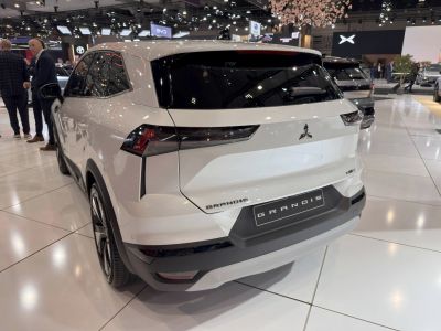 Rear view of a white SUV with modern angular LED tail lights and hybrid badge.