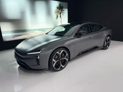 Matte-finished electric luxury sedan front side with aerodynamic design and distinct headlights