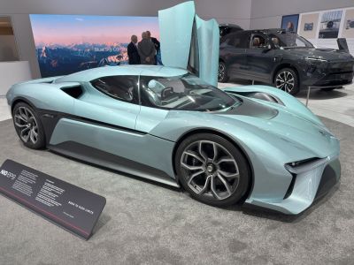 Streamlined electric supercar with butterfly doors