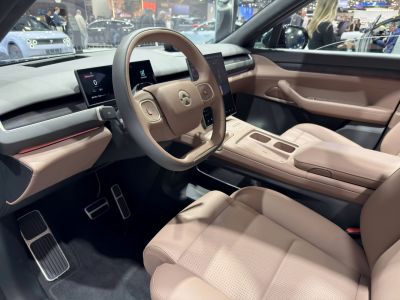 Minimalist beige interior with digital instrument cluster and touchscreen display