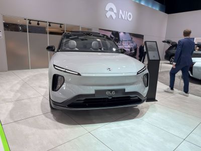 Front profile of modern electric SUV with sleek headlights and smooth body lines.