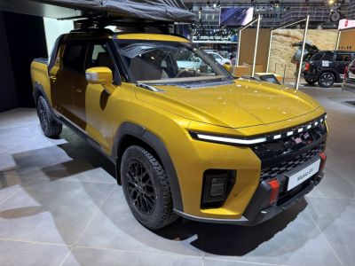 Futuristic electric pickup with sleek LED headlights and rugged wheels