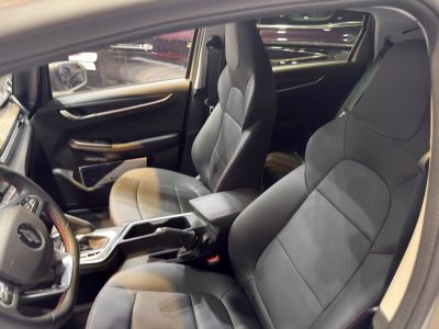 Modern black leather front seats with sleek interior design.