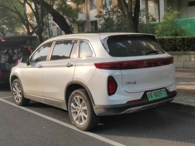 Rear side view of electric SUV with sleek taillights and aerodynamic design.
