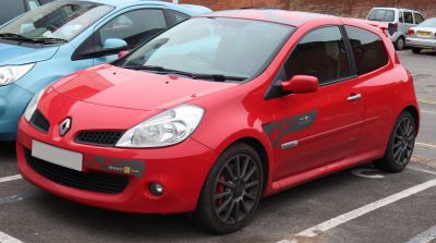 Sporty red hatchback with decals and gray alloy wheels