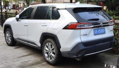 Rear and side view of white hybrid SUV with alloy wheels and distinct taillights