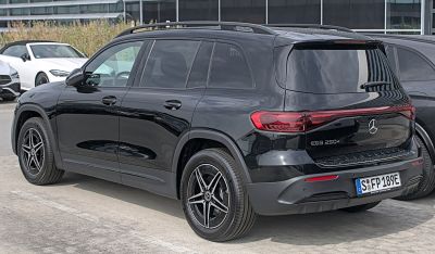 Black Mercedes EQB 250+ rear side with taillights and alloy wheels