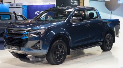 Modern electric double cab pickup with sharp headlights and black rims