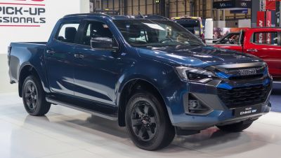 Double cab electric pickup with sleek black rims and LED headlights