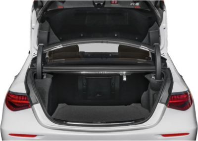 Open trunk of a luxury sedan with spacious interior and dual gas struts