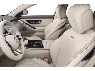 Luxury beige leather seats and advanced controls in a spacious car interior