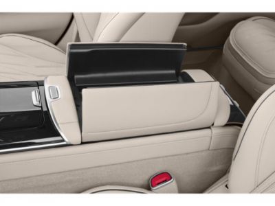 Beige leather seats and modern center console with open storage compartment