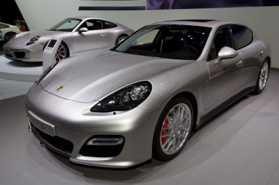 Front-side view of silver luxury sedan with distinctive headlights and sporty wheels