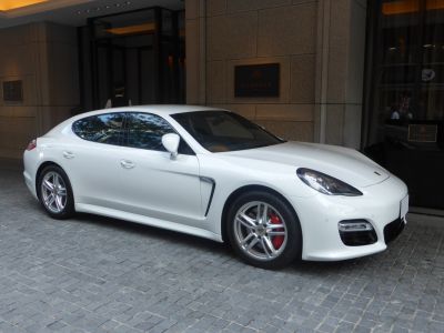 White luxury sedan with alloy wheels and sleek side profile