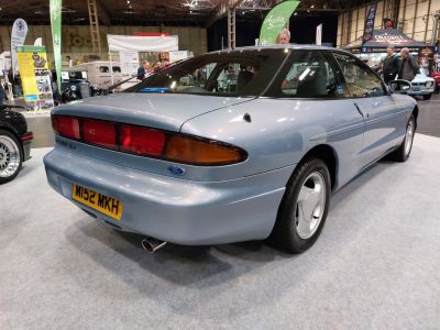 Rear and side view of a sleek 1993 sports coupe with distinctive taillights.