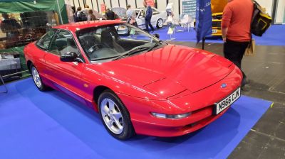 Red 1993 coupe with pop-up headlights and sporty alloy wheels