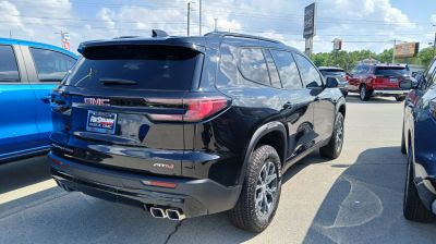 Rear view of black SUV with AT4 trim and dual exhaust pipes