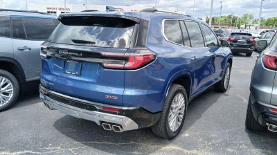 Rear and side view of blue SUV with modern tail lights and dual exhaust