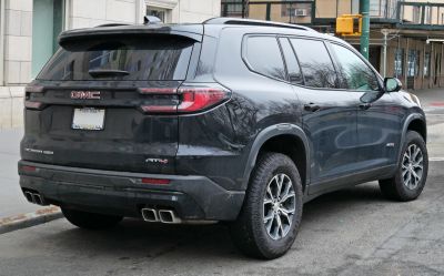 Rear and side view of SUV with quad exhausts and tinted windows