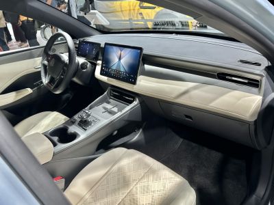 Dual digital displays and modern dashboard with beige seats