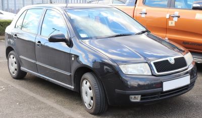Boxy compact hatchback with chrome grille and fog lights