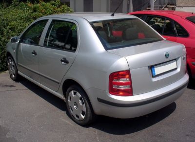 Silver compact sedan rear-side view with taillights and alloy wheels