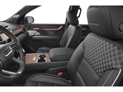Luxury leather seats with intricate stitching and wood trim interior