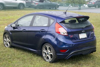 Rear view of sporty hatchback with distinctive taillights and alloy wheels.