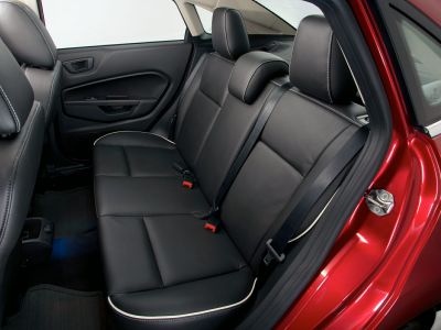 Black leather rear seat with white piping and headrests
