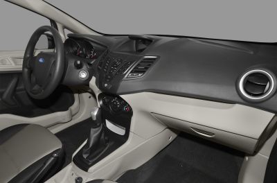 Dashboard and manual gear shift in compact sedan interior