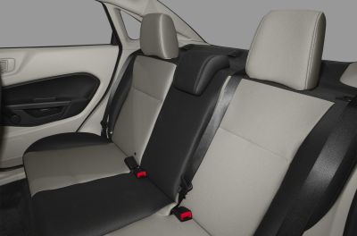 Two-tone rear sedan seats with headrests and seat belts