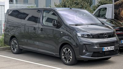 Front and side view of a sleek modern minivan with tinted windows and alloy wheels