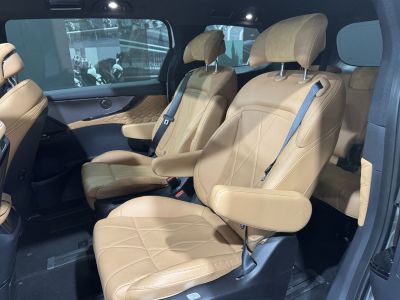 Plush tan leather seats with armrests and quilted door panels