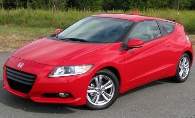 Front-side view of red hatchback with alloy wheels and sleek headlights