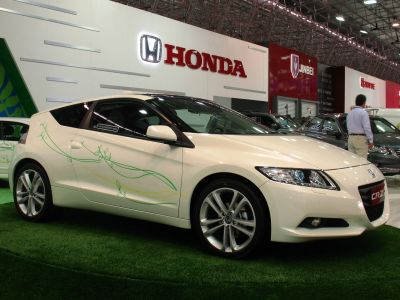 Sporty coupe with green leaf graphics and alloy wheels, front-side angle.