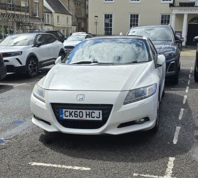 Front view with sharp headlights and sporty grille