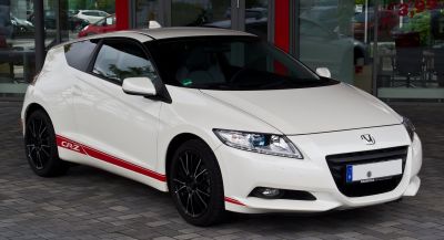Sporty white coupe with black wheels and red stripes