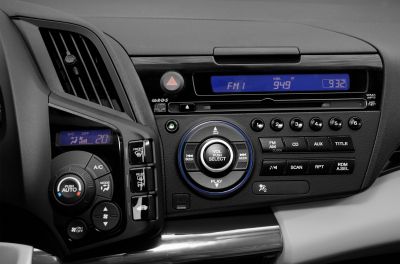 Car radio and automatic climate control panel with buttons and display screens.
