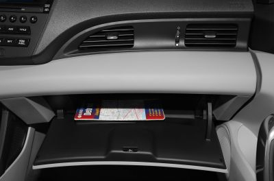 Open glove box and dashboard air vents with radio controls