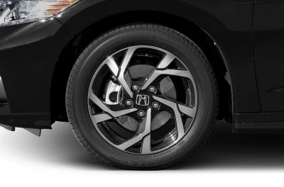 Alloy wheel and tire close-up with detailed spoke design and brake disc