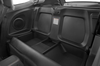 Rear storage compartment and speakers in compact hatchback interior