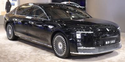 Luxury black sedan with distinctive alloy wheels and modern lighting