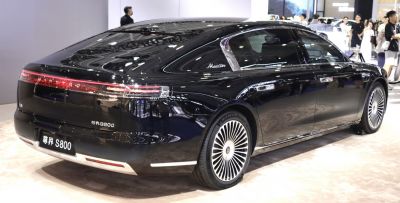 Sleek black sedan rear with LED tail lights and alloy wheels.