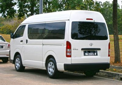 Long white van with high roof, tinted rear and side windows, 4-door design