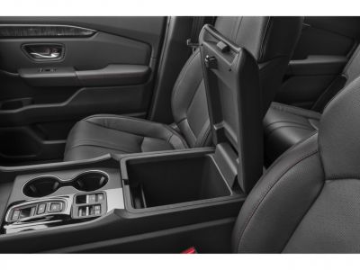 Open center console with leather seats and red stitching
