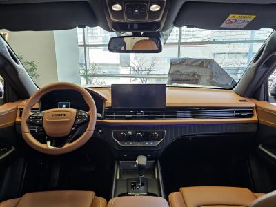 Modern brown leather interior with dashboard and steering wheel.