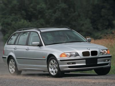 Silver estate car front and side view on gravel road