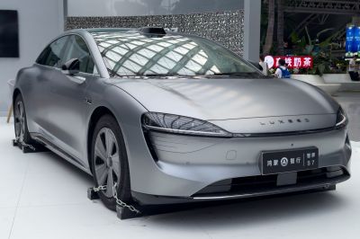 Sleek aerodynamic front design with modern headlights and matte finish.