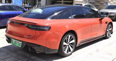 Rear and side view of a sleek electric sedan with LED taillights and aerodynamic design