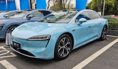 Sleek electric sedan front and side with LED headlights and aerodynamic styling